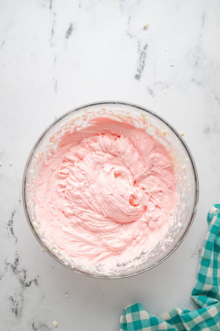 Pink buttercream frosting in a bowl