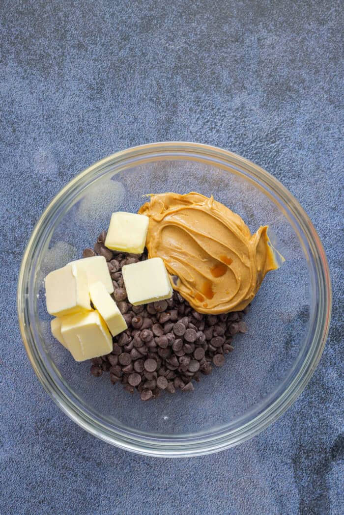 Butter, peanut butter, and chocolate chips in a bowl