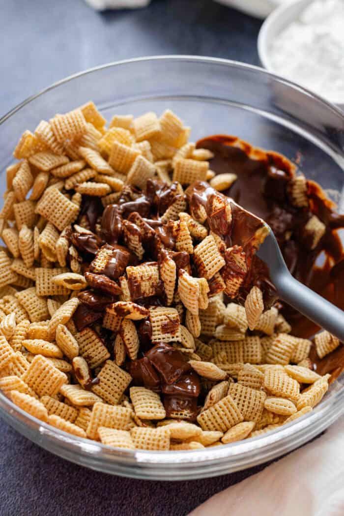 Stirring melted chocolate with Chex cereal