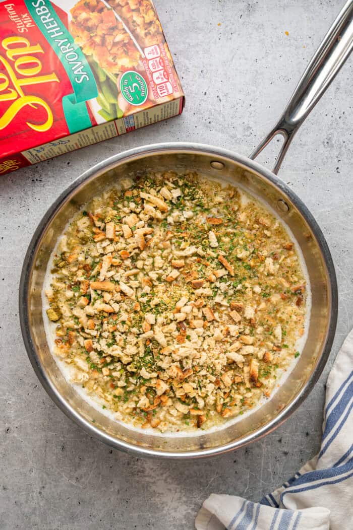 Stuffing mix soaking in chicken broth in a bowl
