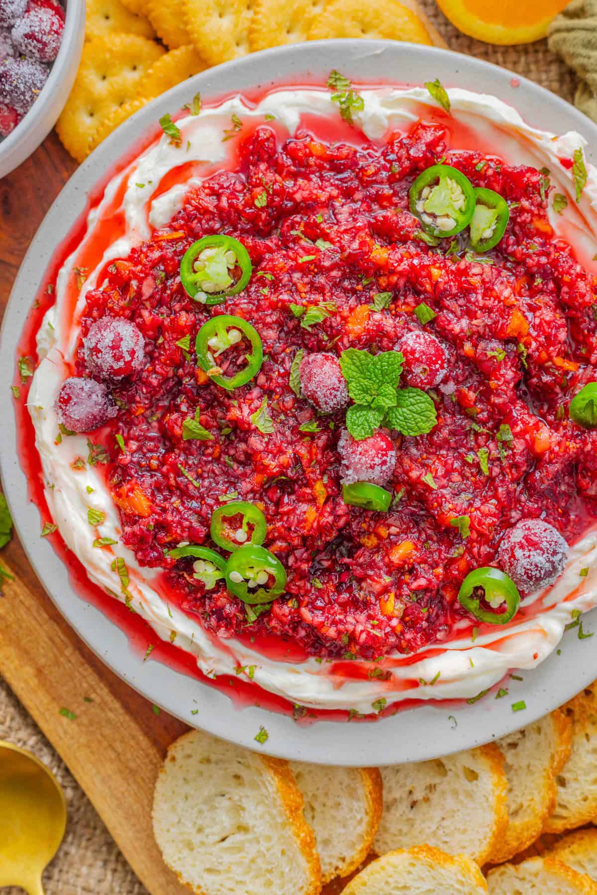 Tart cranberries, spicy jalapenos, and warm spices combine in this Cranberry Jalapeno Dip. A unique blend of tart, sweet, and spicy! Cranberry jalapeno dip on a serving plate