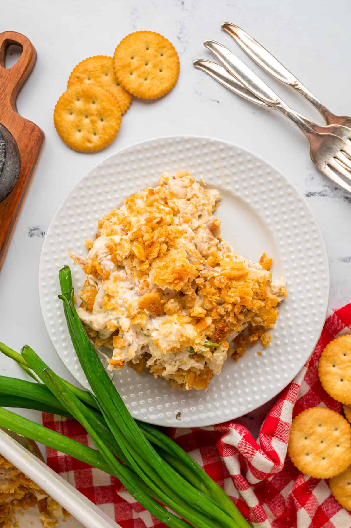 Overhead view of as serving of Ritz chicken casserole on a white plate