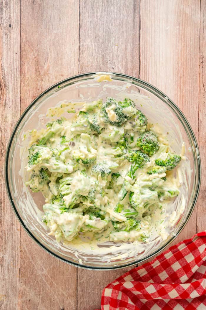 Broccoli mixed with mushroom soup and mayo in a bowl