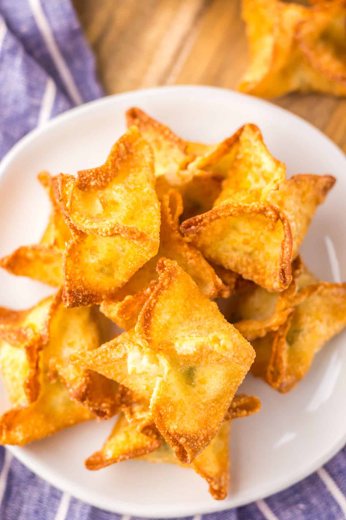 Copycat Panda Express Cream Cheese Rangoon are so easy to make with just 4 ingredients! Better than takeout! A plate of cream cheese wontons