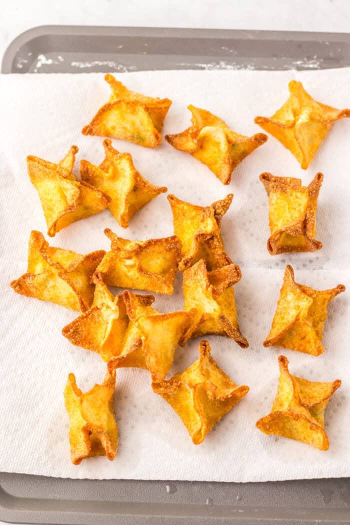 Cream cheese wontons on a paper towel