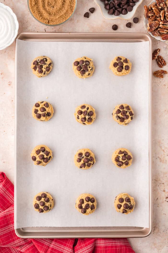 Chocolate chips pressed into balls of cookie dough