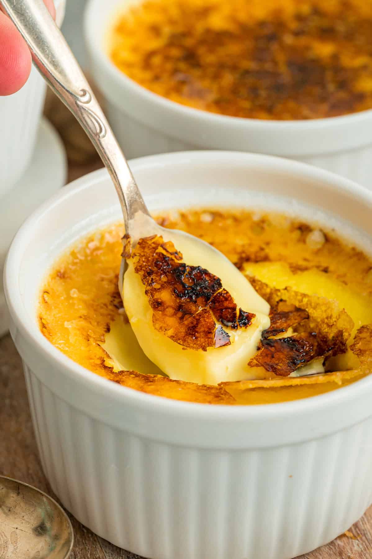A spoon in a ramekin of creme brulee