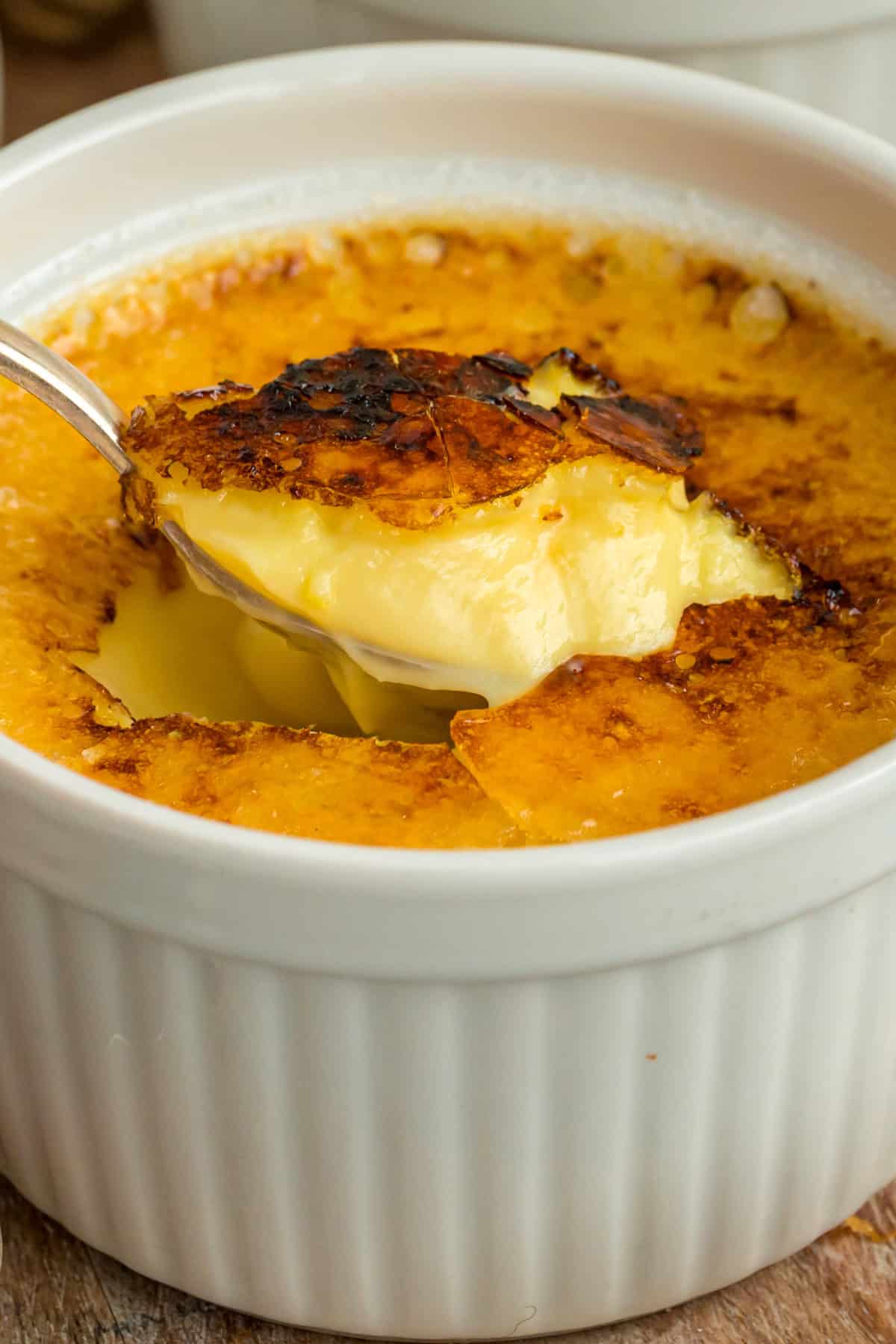 Crème Brûlée is a dessert meant to impress. This recipe is made with just 4 ingredients and it's so surprisingly easy. Creme Brulee with a spoon