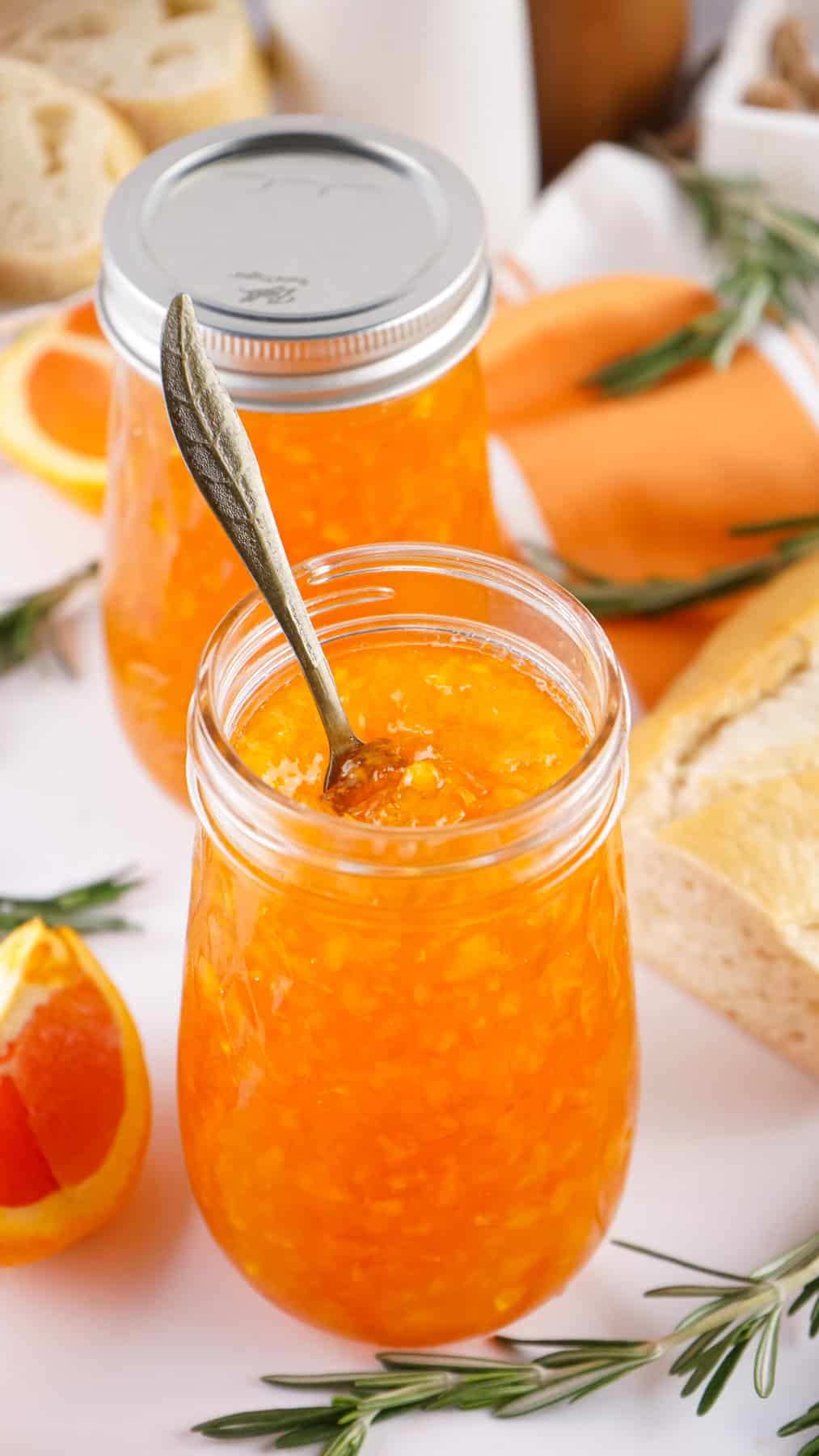 A spoon in a jar of orange marmalade