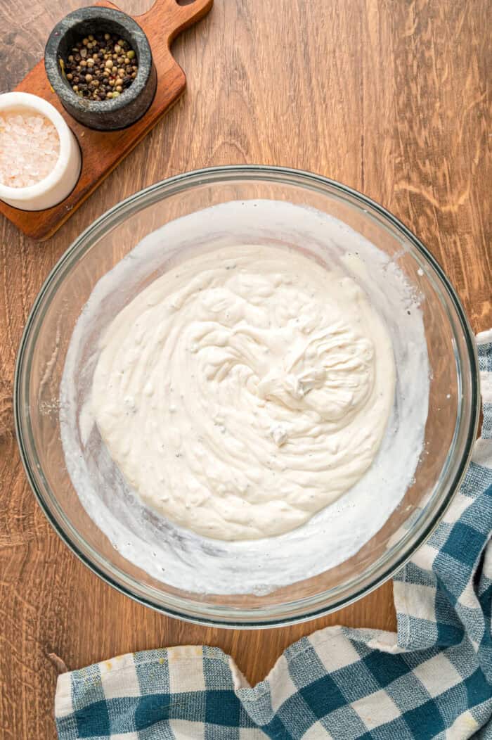 Cream of mushroom soup, sour cream, and milk in a bowl
