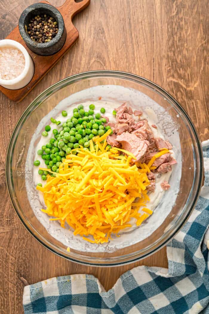 Peas, tuna, shredded cheese, added to a soup and sour cream mixture