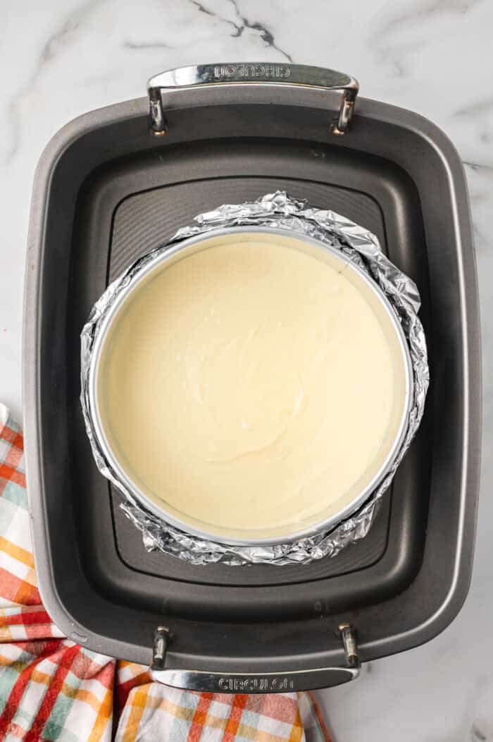 A cheesecake in a water bath