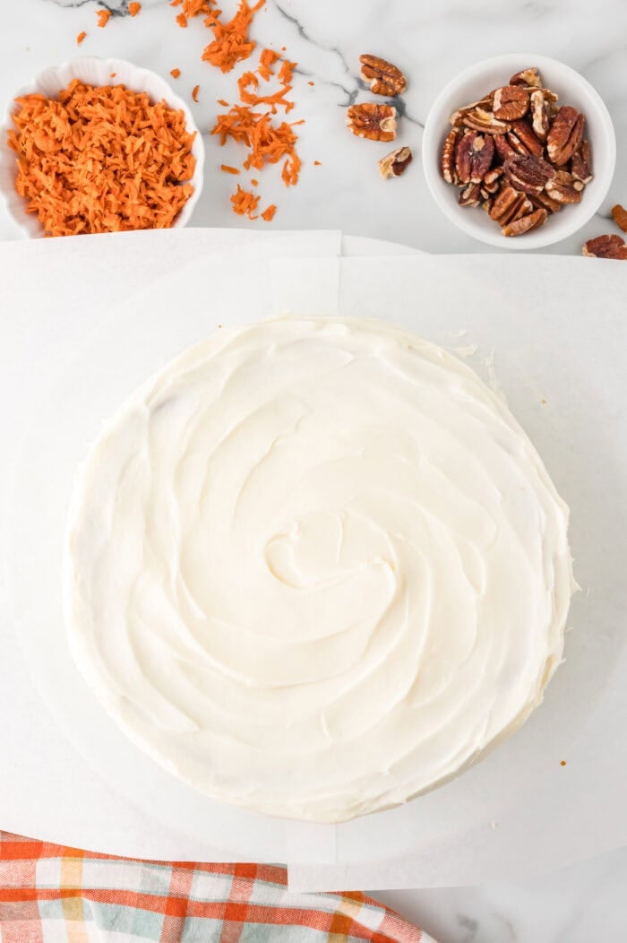 Overhead view of a frosted carrot cake cheesecake