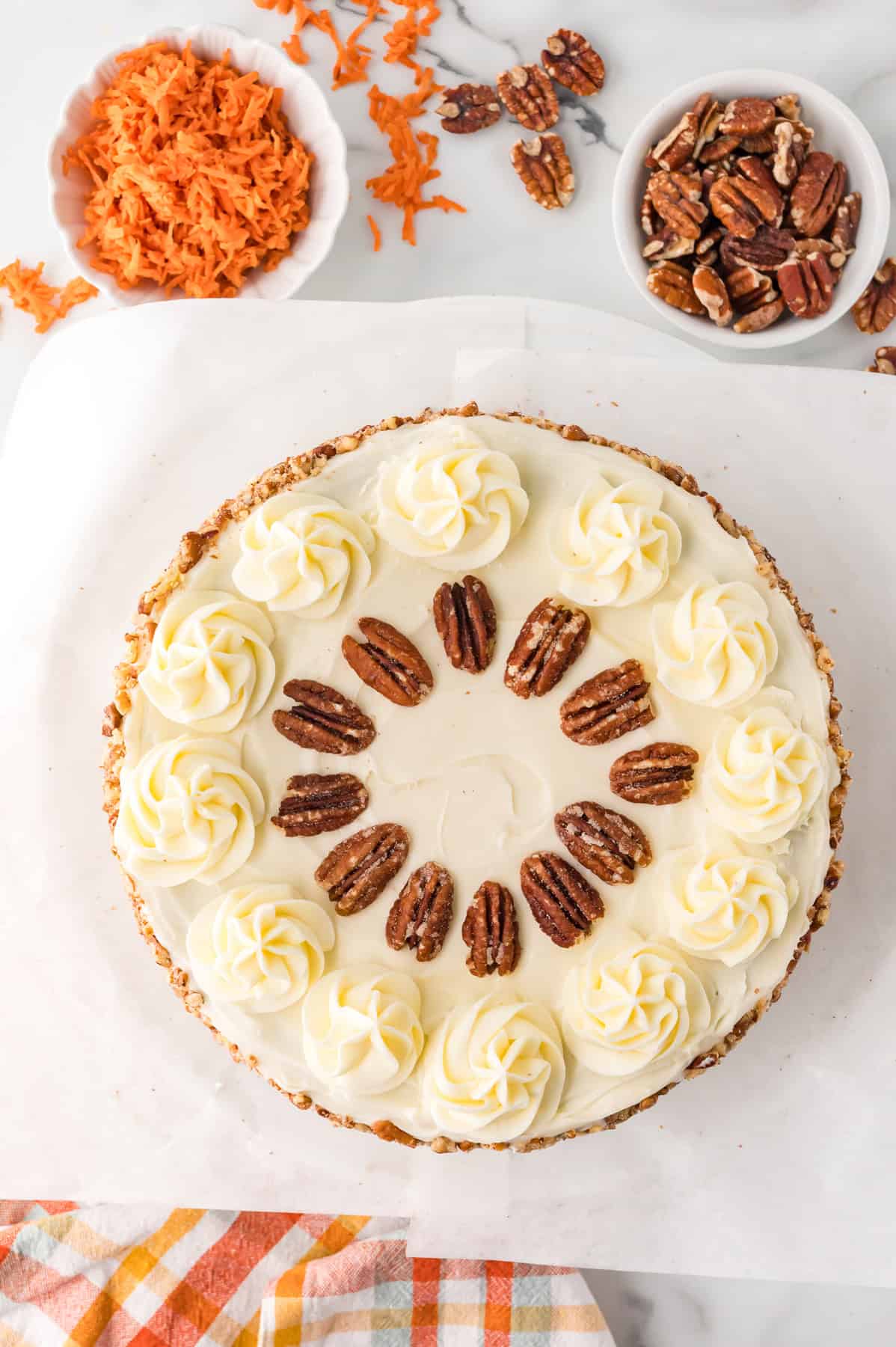 Overhead view of a decorated carrot cake cheesecake