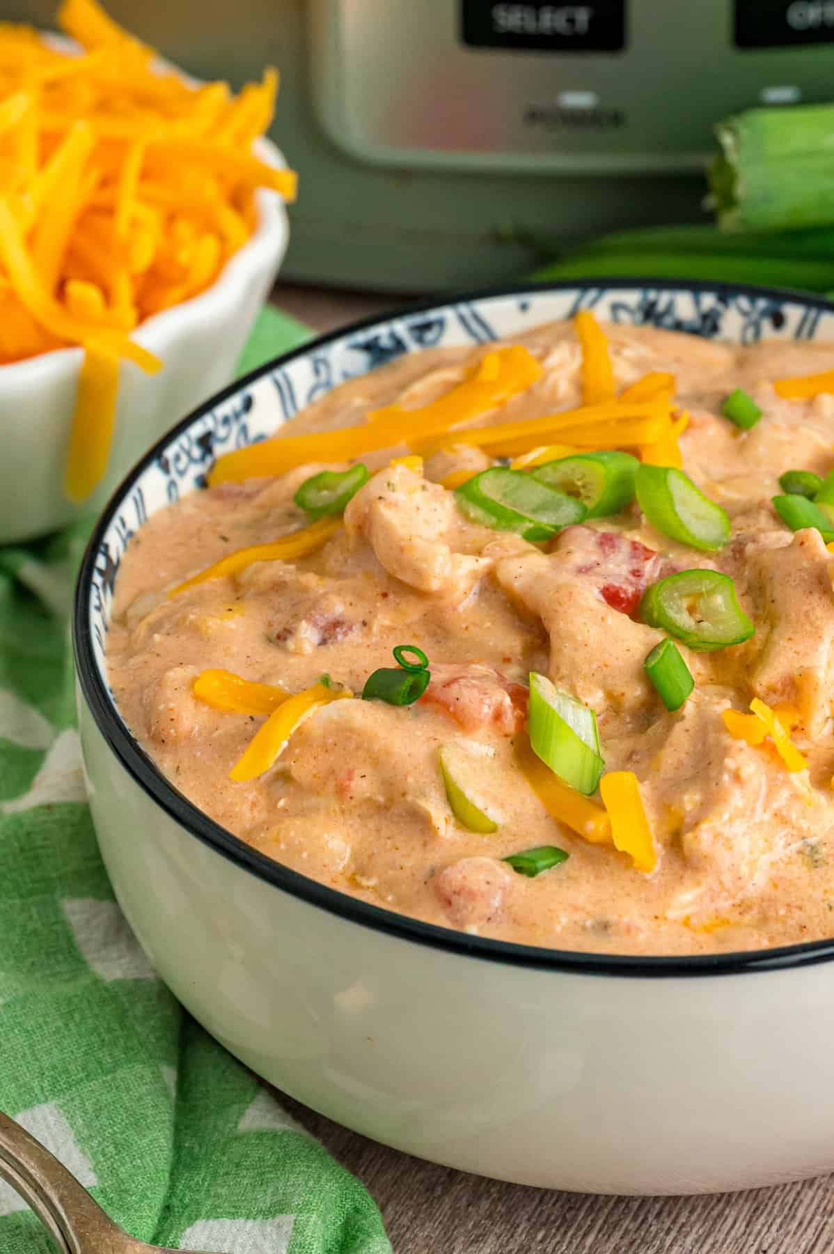 This Crack Chicken Chili is made in the crockpot with shredded chicken, cream cheese, cheddar cheese, bacon, Rotel, and white beans. A bowl of crack chicken chili
