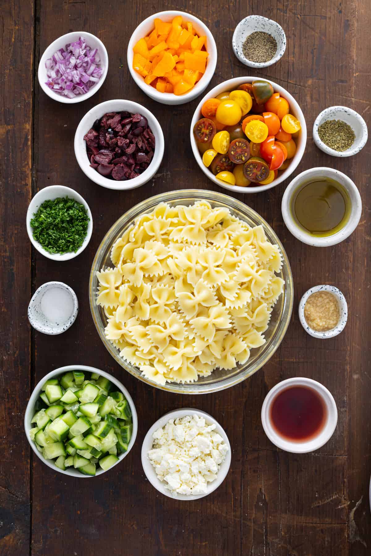 Overhead view of ingredients needed to make Greek pasta salad