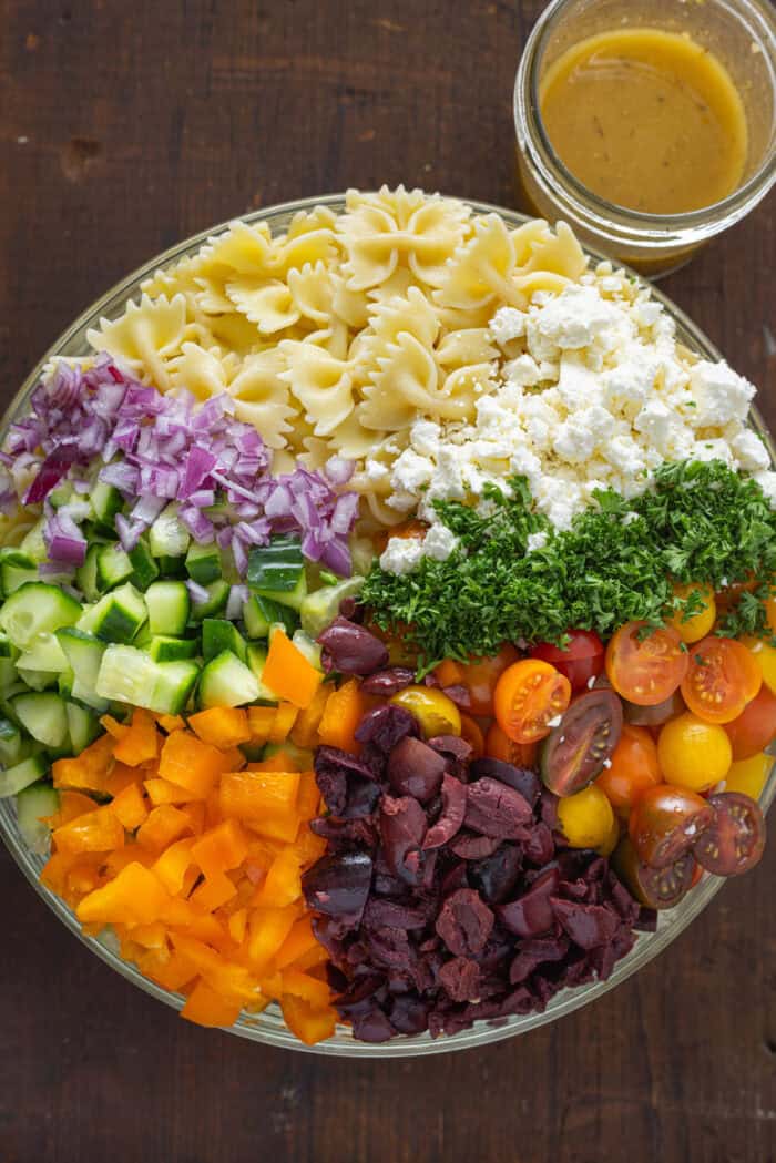 Pasta, feta, veggies, and cilantro in a bowl