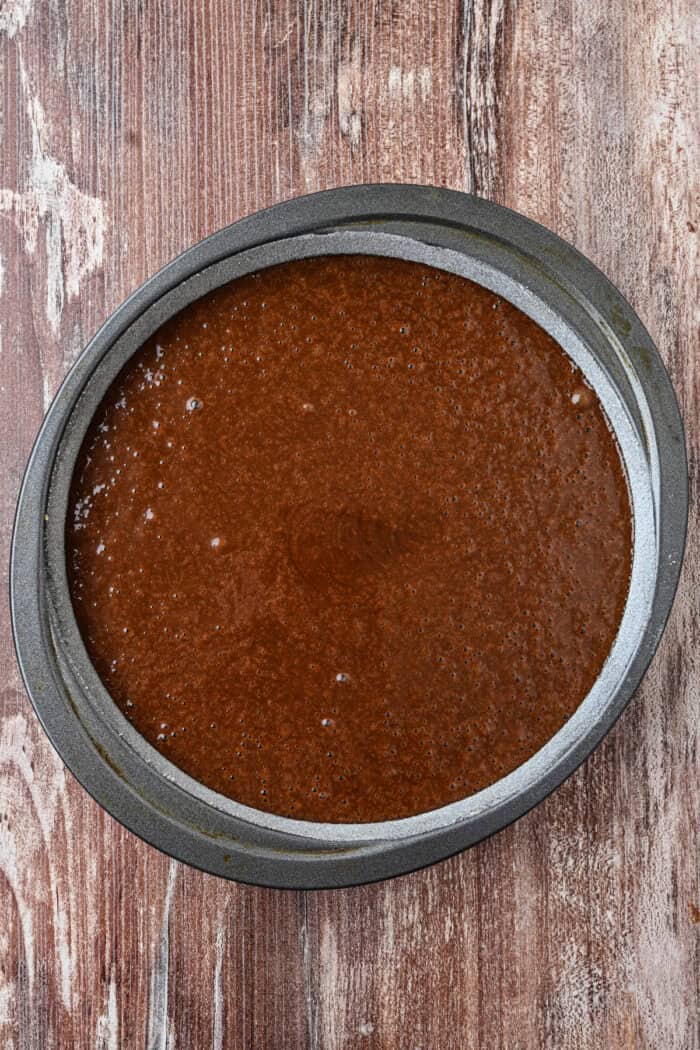 Chocolate cake batter in a round pan