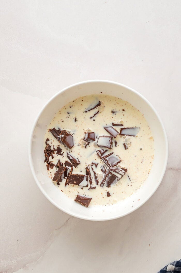 Heavy cream and chopped chocolate in a bowl