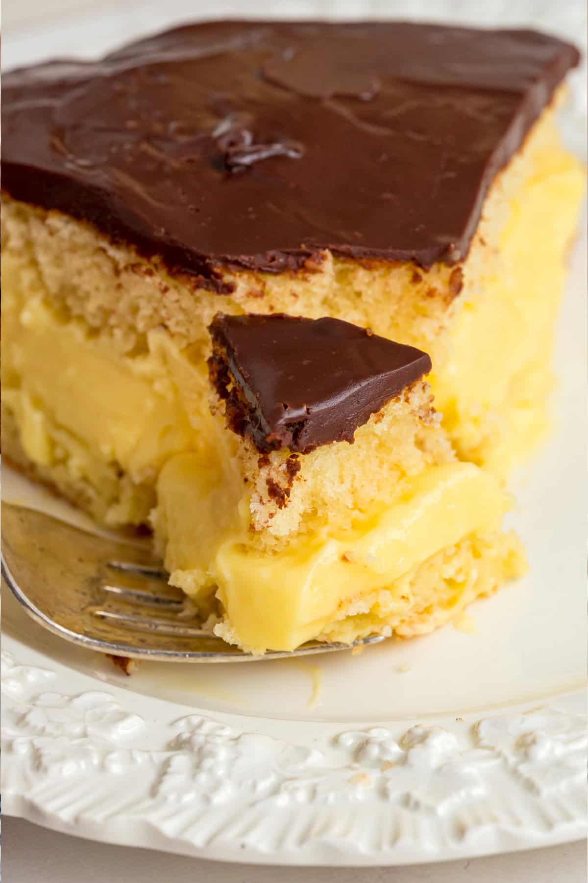 a bite from a slice of Boston Cream Pie