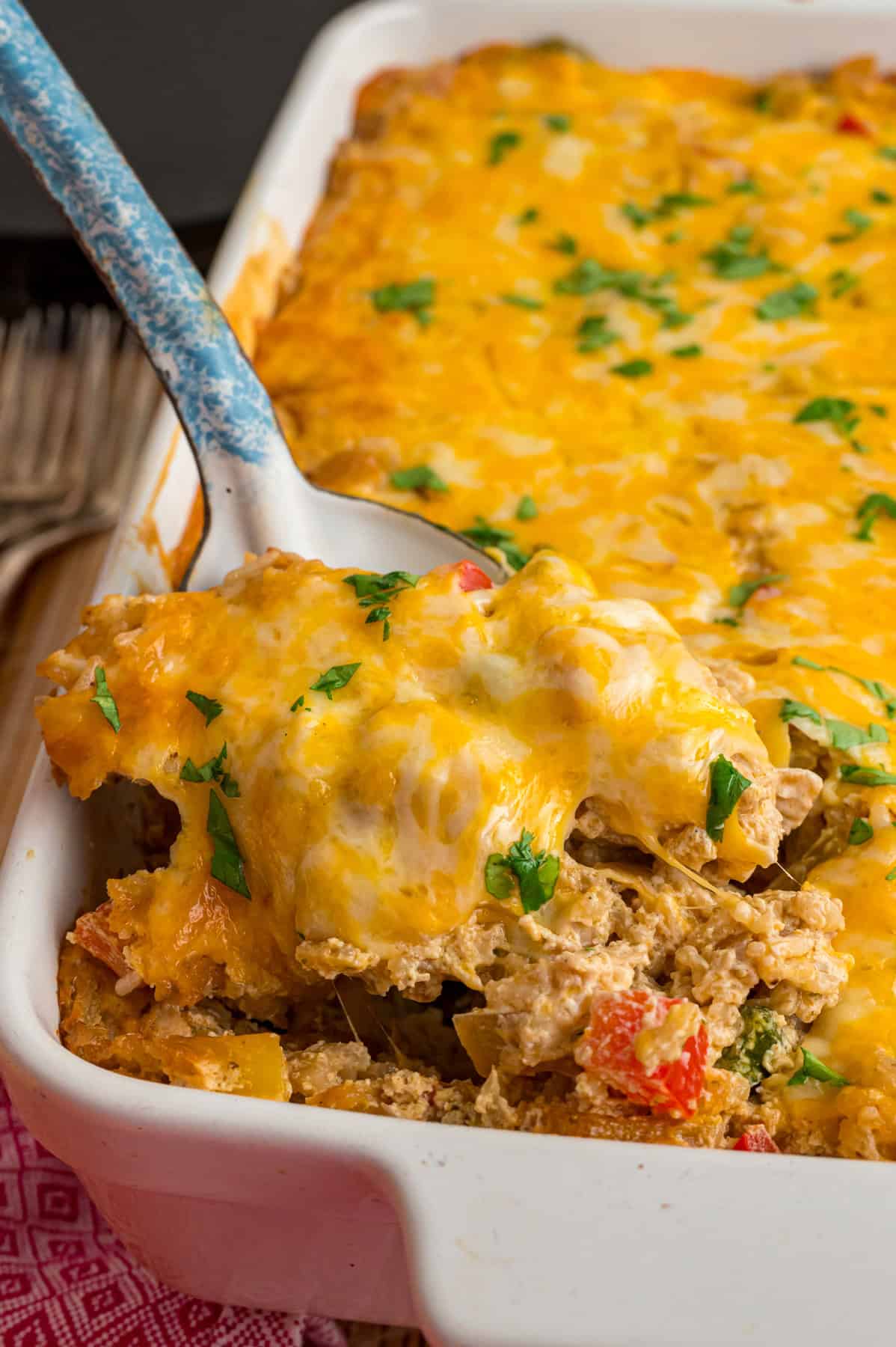 A serving spoon in chicken fajita casserole