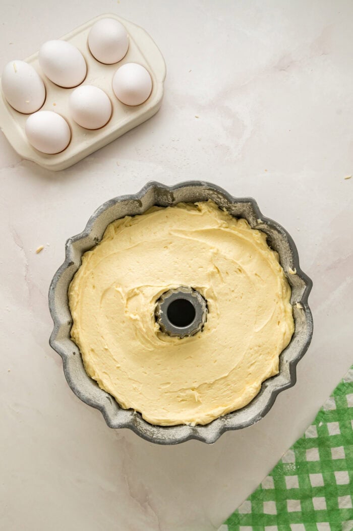 Ultra moist and dense with a tender crumb, this Cream Cheese Pound Cake offers a rich buttery vanilla flavor. Pound cake batter smoothed out in a bundt pan