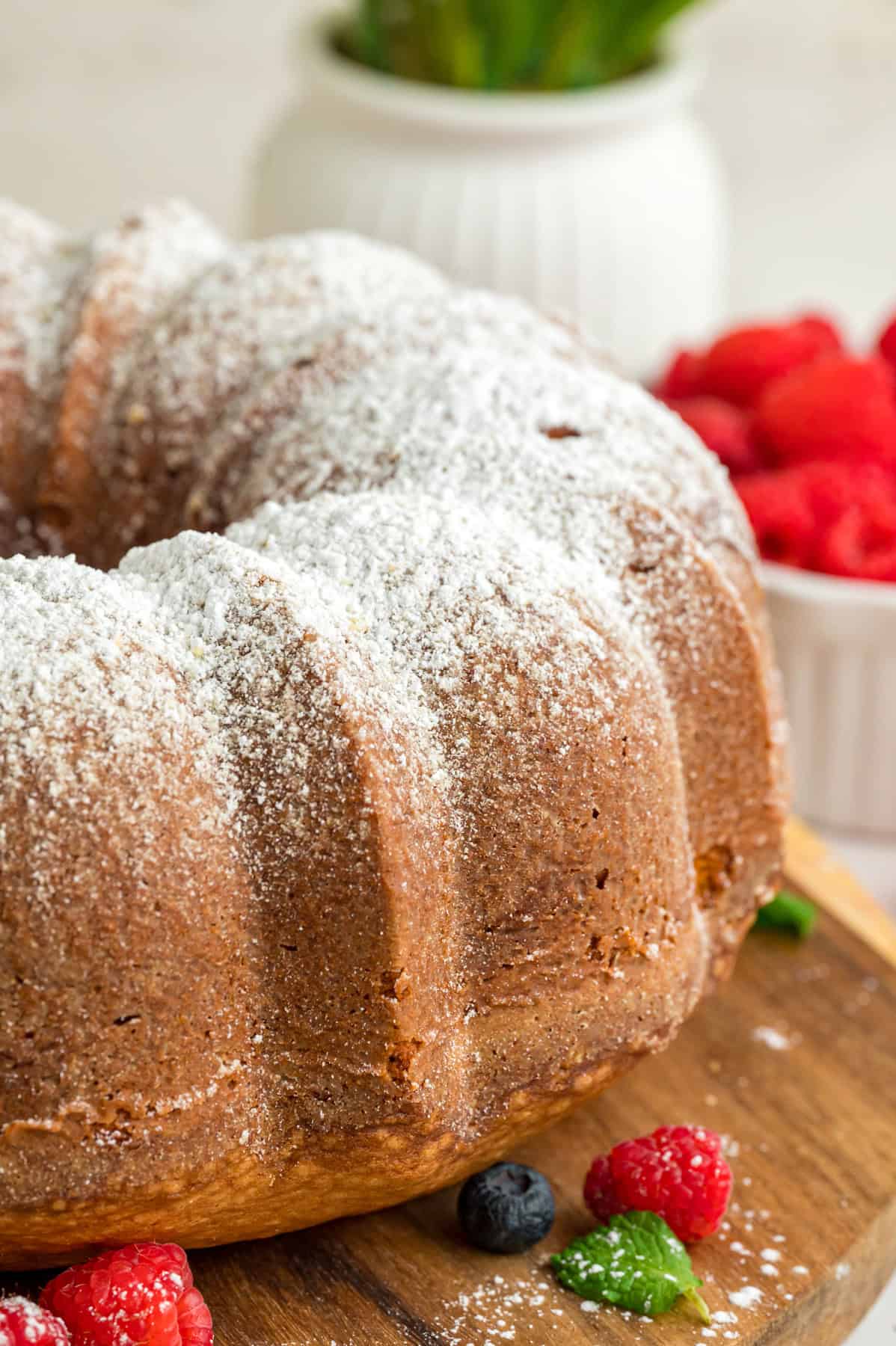 Ultra moist and dense with a tender crumb, this Cream Cheese Pound Cake offers a rich buttery vanilla flavor. A cream cheese pound cake on a wooden board