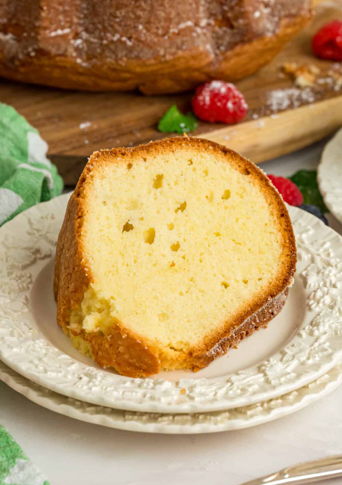 Ultra moist and dense with a tender crumb, this Cream Cheese Pound Cake offers a rich buttery vanilla flavor. a slice of cream cheese pound cake on a plate