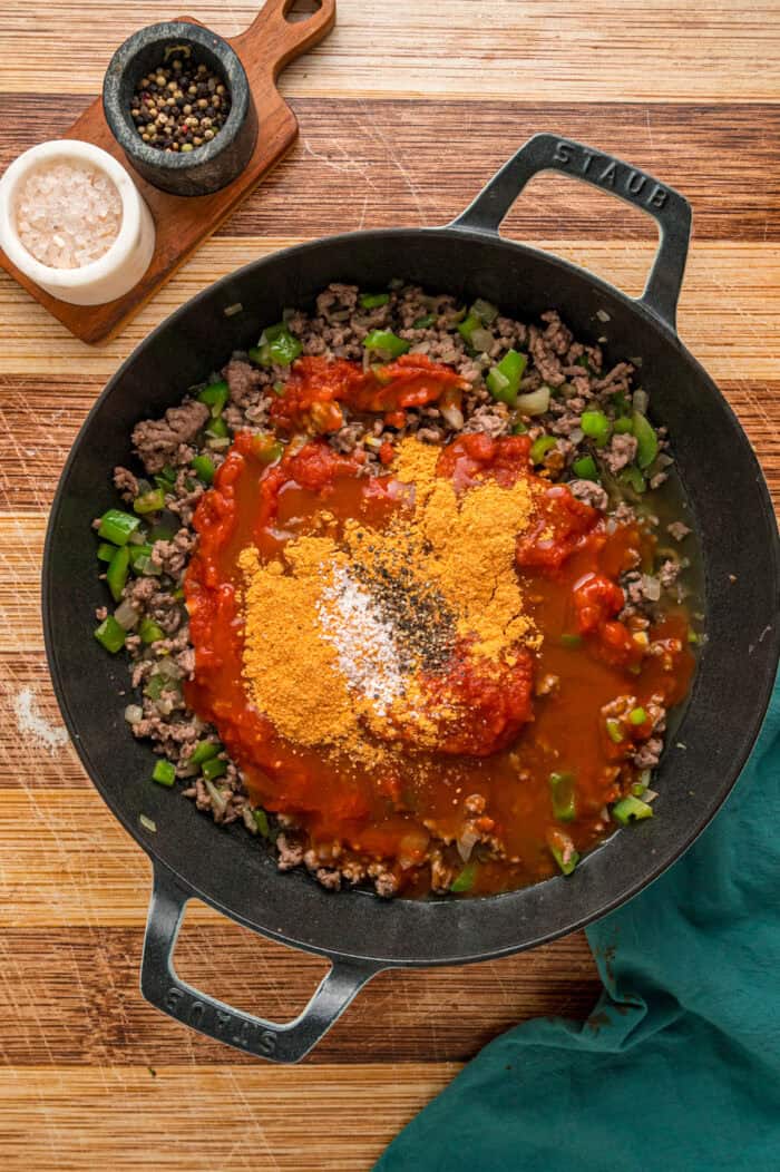 Enchilada sauce and spices added to ground beef