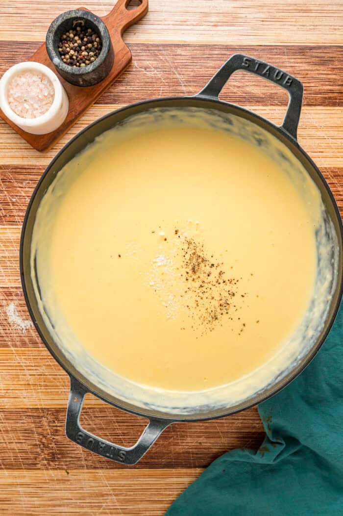 Salt and pepper added to a cheese sauce