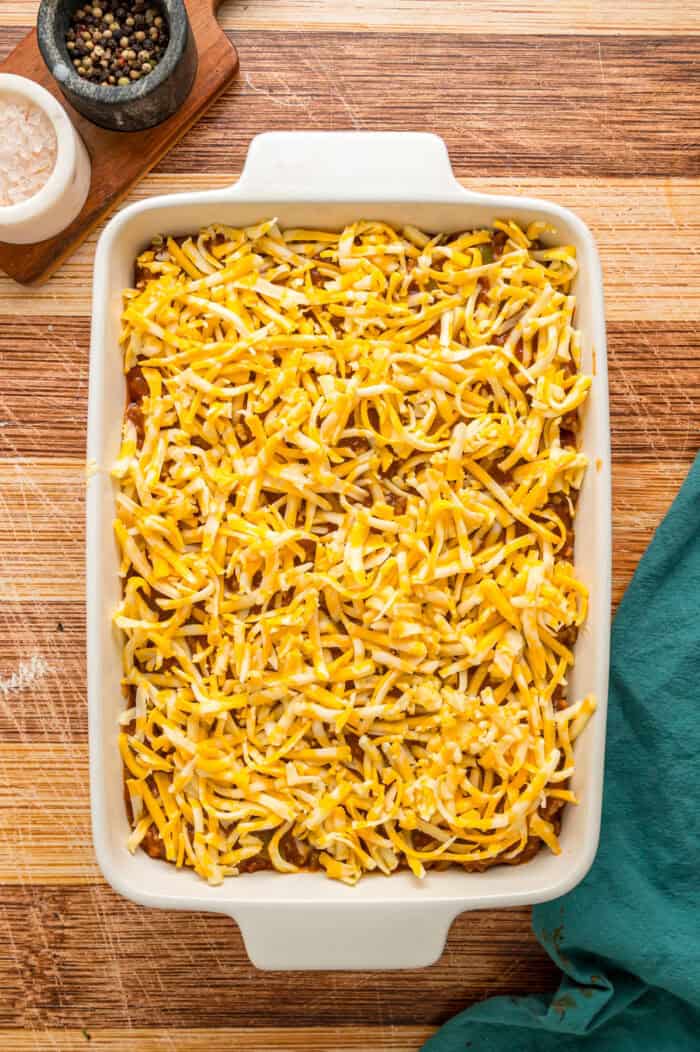Shredded cheese on top of meat sauce