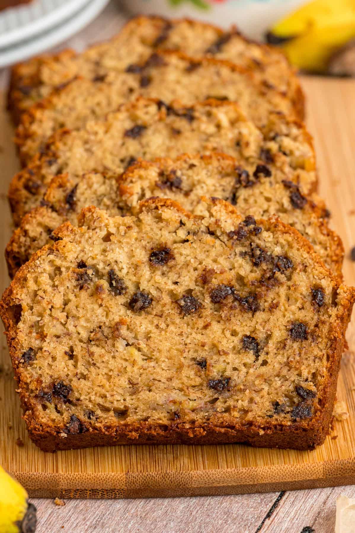Creamy peanut butter, bananas, and mini chocolate chips combine in this Peanut Butter Banana Bread. It's moist, dense, and so easy to make. Sliced peanut butter banana bread on a cutting board