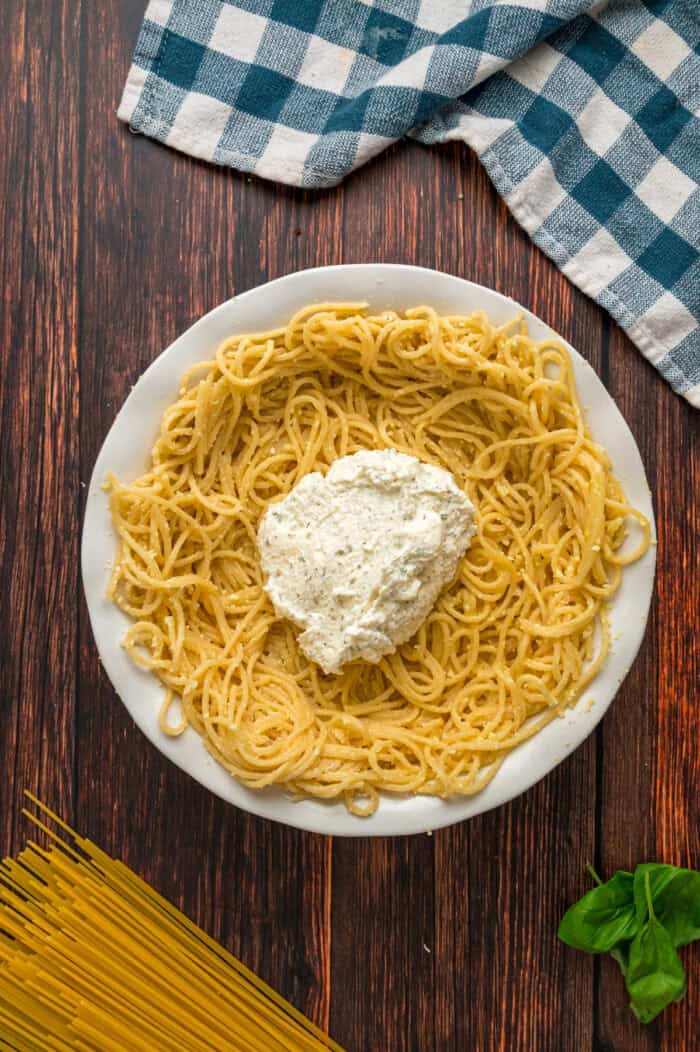 Ricotta added to a spaghetti pie crust