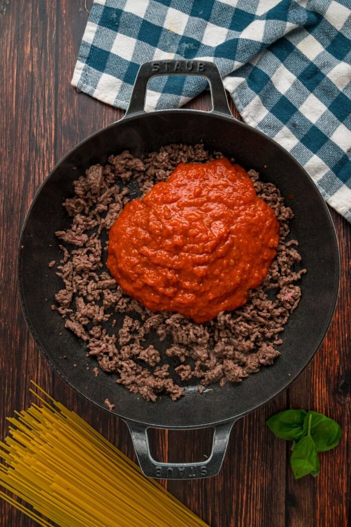 Marinara sauce and ground beef in a skillet