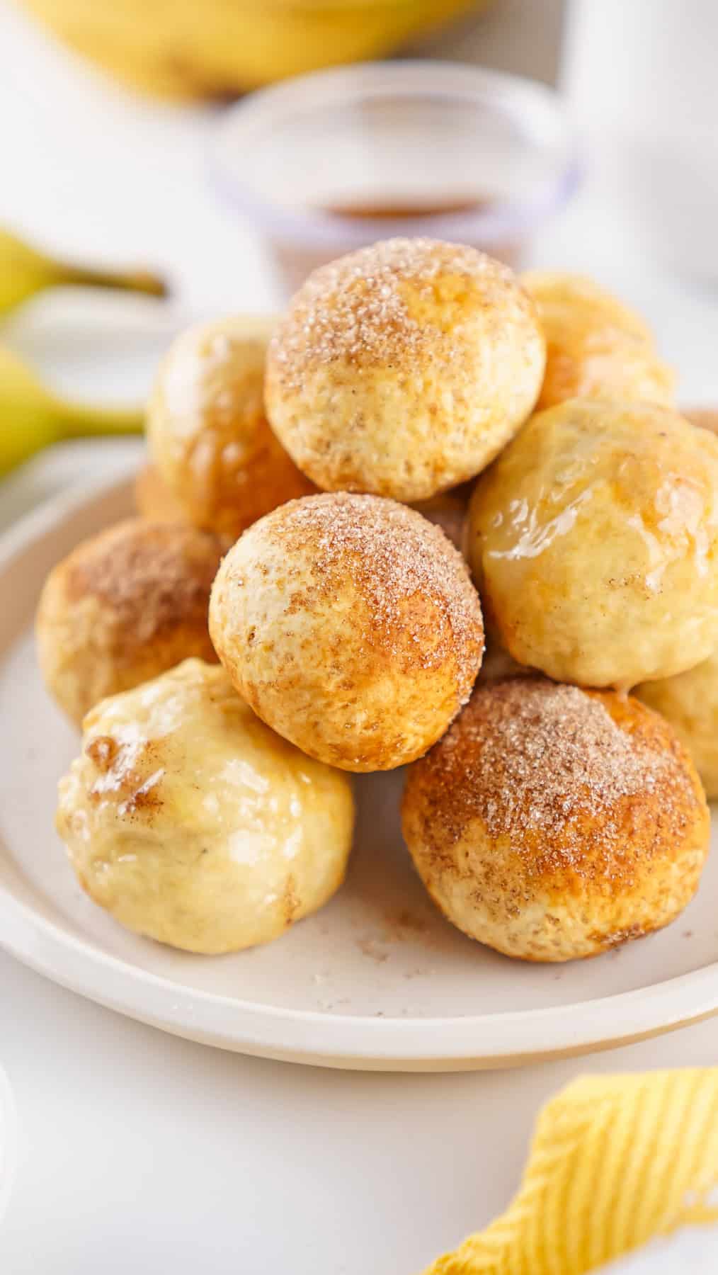 These banana donut holes are made in the air fryer with just 2 ingredients, plus an optional cinnamon sugar or banana glaze topping. A plate of banana donut holes