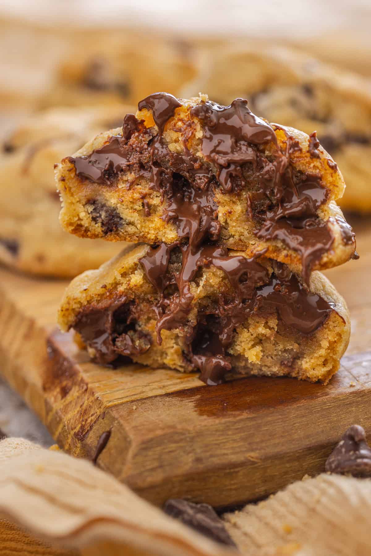 These Gooey Chocolate Chip Cookies are crisp and brown on the edges but have an ooey, gooey, and super soft center. Ready in 20 minutes! Two halves of a gooey chocolate chip cookie stacked on each other