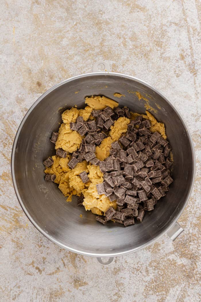 Adding chocolate chips to cookie dough