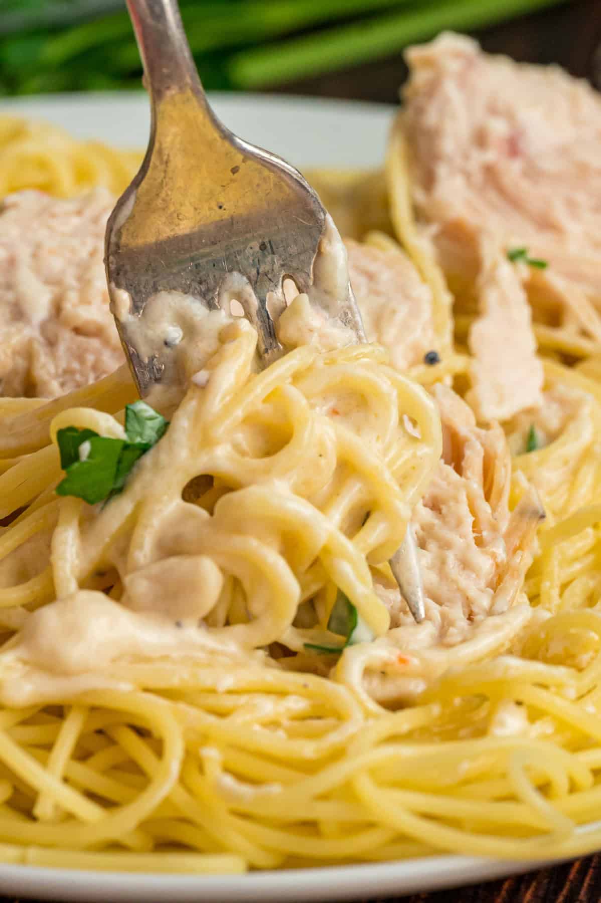 A fork swirling angel chicken pasta