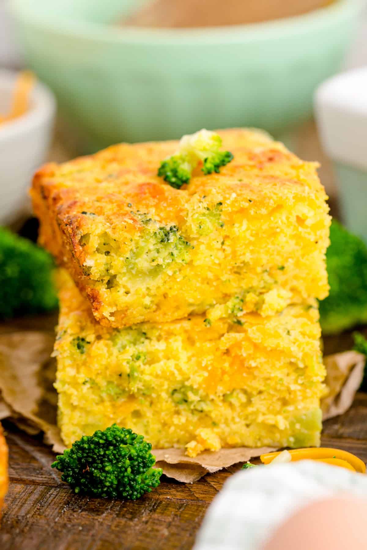 This Cheesy Broccoli Cornbread starts with a box of Jiffy mix that is combined with cheddar cheese, cottage cheese, broccoli and a few other ingredients. Broccoli Cheese Cornbread slices stacked