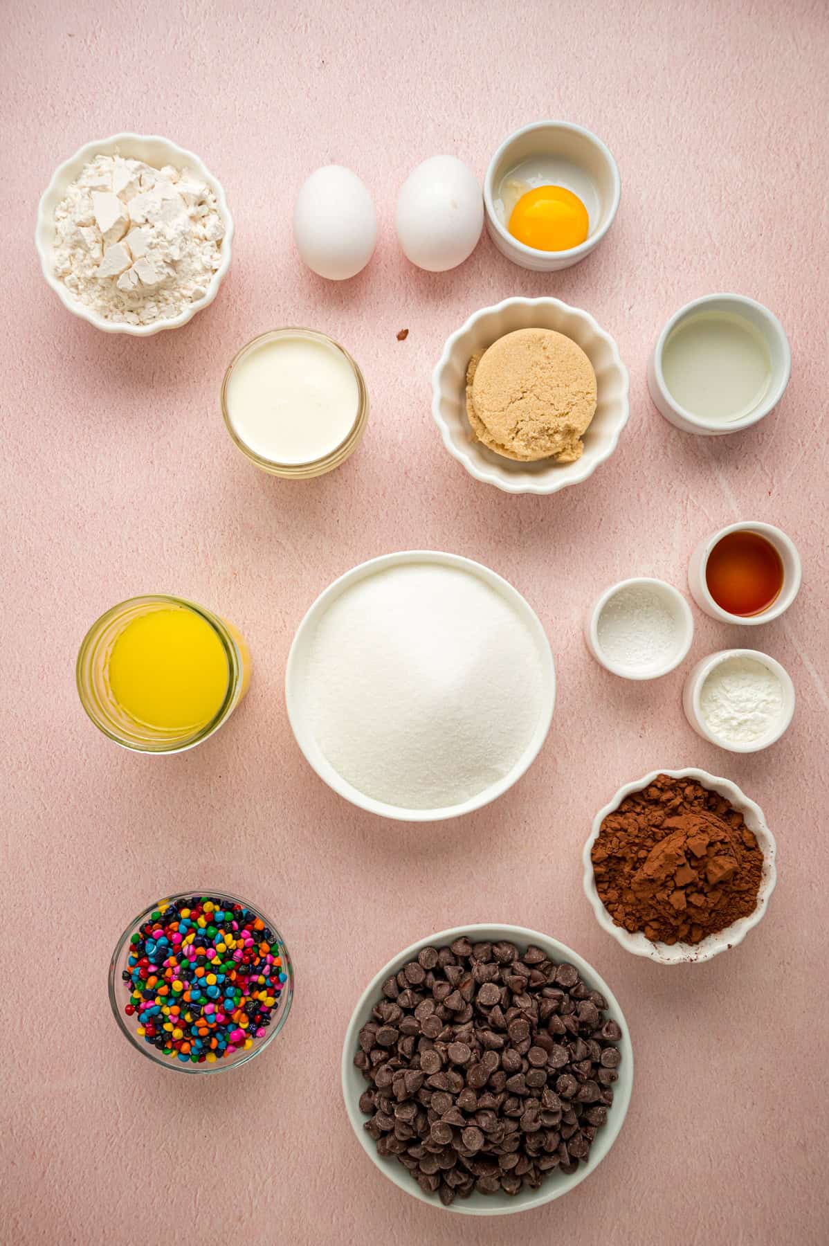 With dense, chewy brownies topped with frosting and rainbow candy-coated chocolate chips, these Cosmic Brownies are a nostalgic treat. Overhead view of ingredients needed to make homemade cosmic brownies