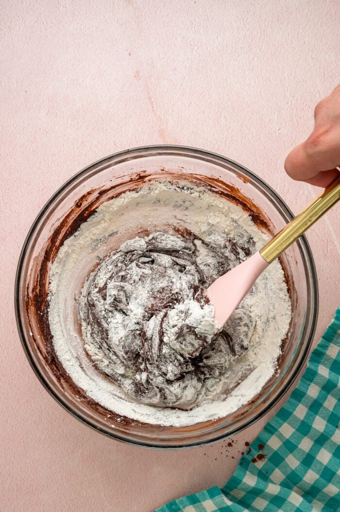 With dense, chewy brownies topped with frosting and rainbow candy-coated chocolate chips, these Cosmic Brownies are a nostalgic treat. Stirring flour into brownie batter