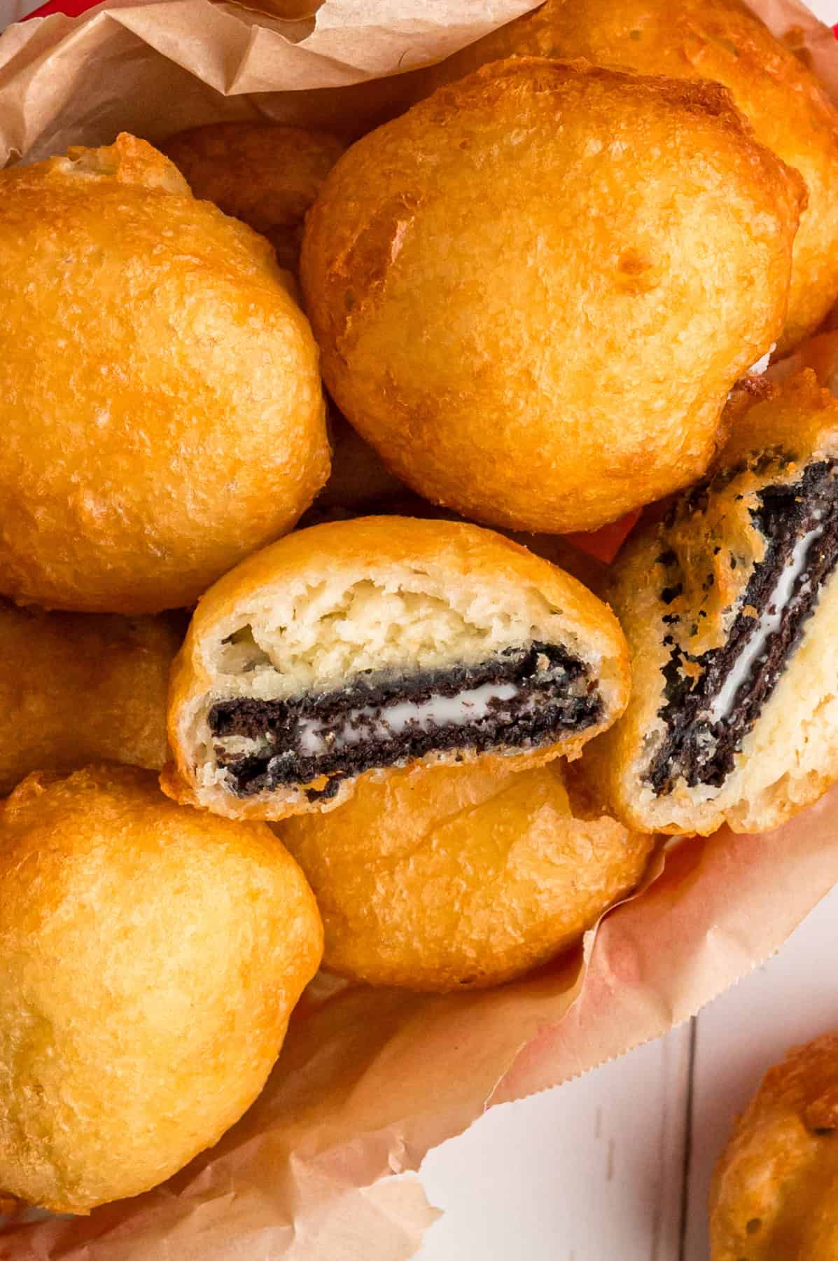 With Oreos coated in pancake batter and fried to golden perfection, this Deep Fried Oreos recipe turns fair food into an anytime treat. Overhead view of a basket of fried Oreos, one cut in half to show the inside