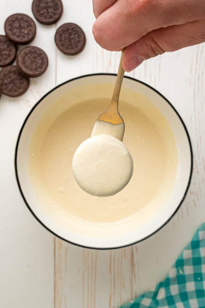 With Oreos coated in pancake batter and fried to golden perfection, this Deep Fried Oreos recipe turns fair food into an anytime treat. An Oreo on a fork coated in pancake batter