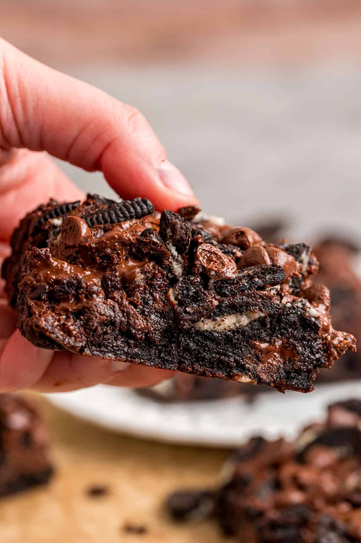 A hand holding an Oreo brownie