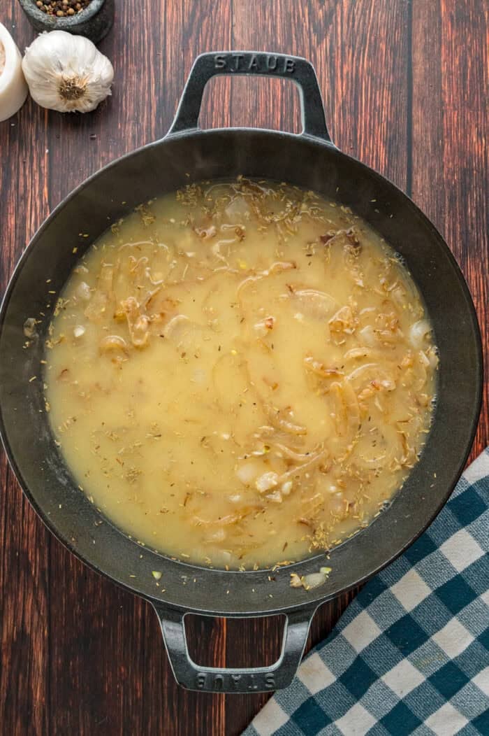 Bone-in pork chops are simmered in a creamy, savory sauce in this Smothered Pork Chops recipe. Serve with mashed potatoes for an easy dinner. Gravy in a skillet
