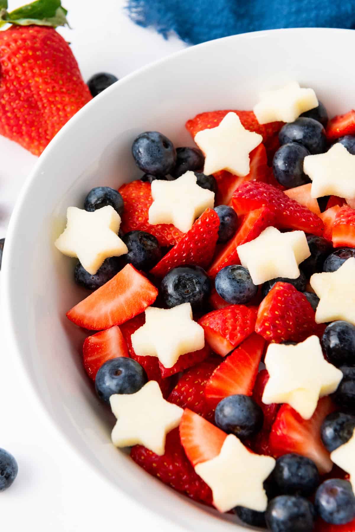 This 4th of July Fruit Salad is so festive and easy to make! It's perfect for Memorial Day, 4th of July or any patriotic gathering. 4th of July Fruit Salad in a bowl