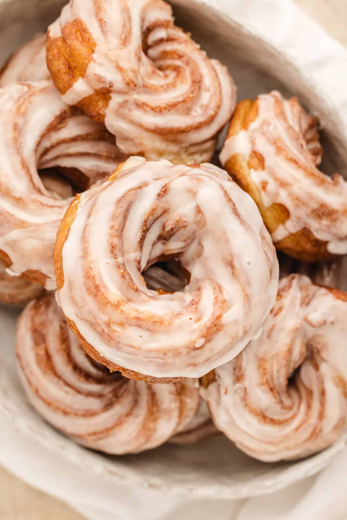 Overhead view of a plate of French cruller donuts