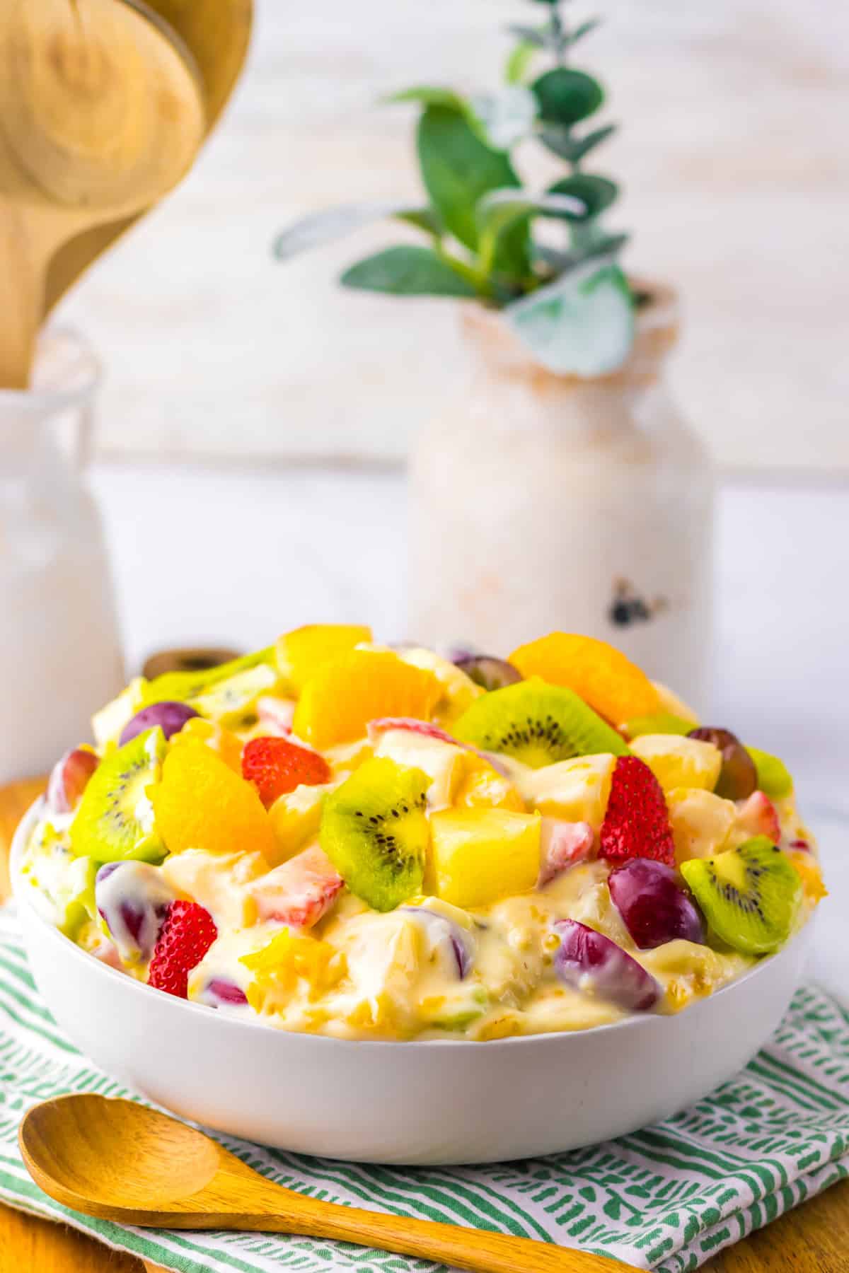 With a variety of fruit tossed in a creamy cheesecake base, this Hawaiian Cheesecake Salad is a tropical dessert perfect for summer. Side view of a bowl of Hawaiian cheesecake salad