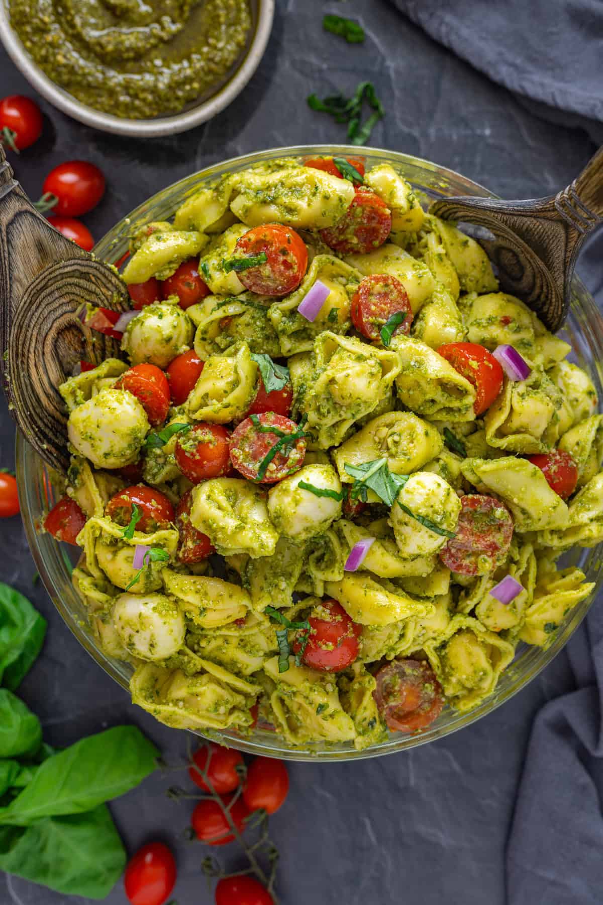 This Tortellini Pasta Salad recipe is made in just 10 minutes with 7 ingredients! Fresh and flavorful, it makes a great lunch or side dish. Overhead view of a bowl of tortellini pasta salad