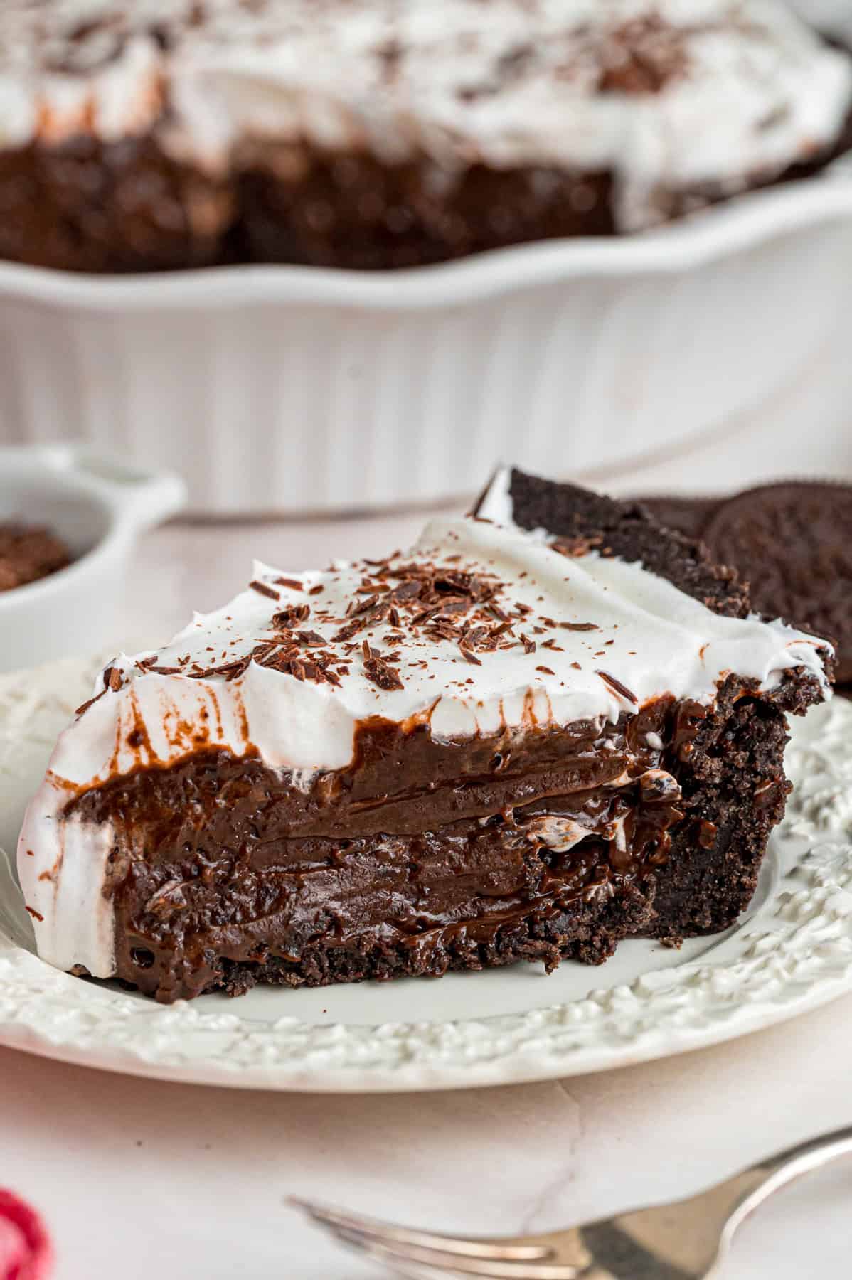 With a smooth, creamy filling in an Oreo crust, this Chocolate Pudding Pie is made in 15 minutes with 5 ingredients & 0 cooking or baking. A slice of chocolate pudding pie on a white plate